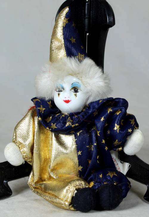 Porcelain and cloth clown dressed in blue and gold