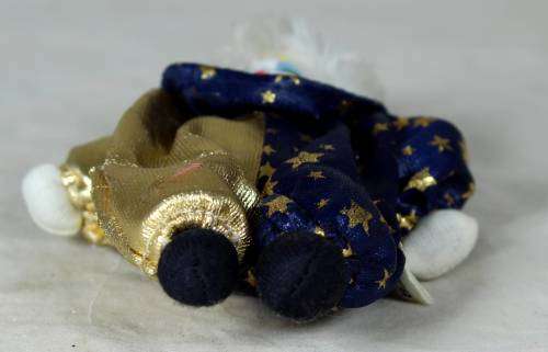 Porcelain and cloth clown dressed in blue and gold