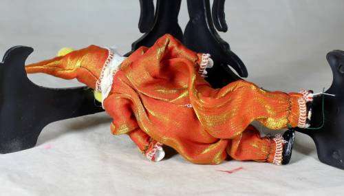 PORCERLAIN AND CLOTH CLOWN DRESSED IN A ORANGE JUMP SUIT