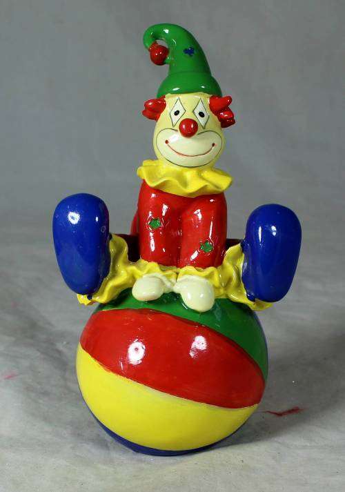 PORCELAIN CLOWN SITTING ON A MONEY BOX BALL