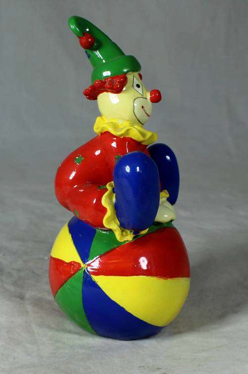 PORCELAIN CLOWN SITTING ON A MONEY BOX BALL