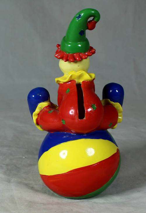 PORCELAIN CLOWN SITTING ON A MONEY BOX BALL