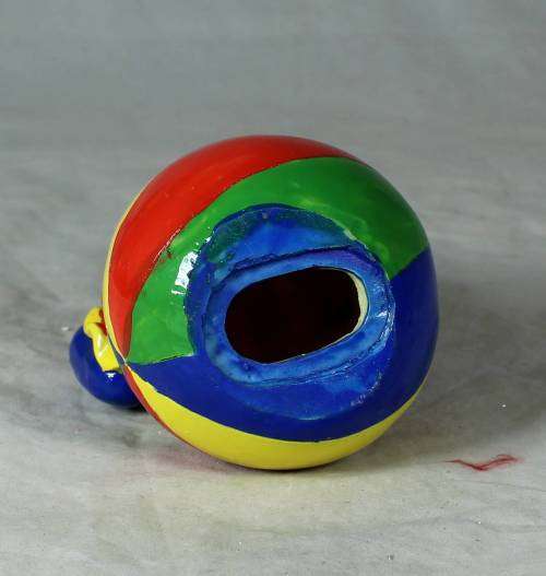 PORCELAIN CLOWN SITTING ON A MONEY BOX BALL