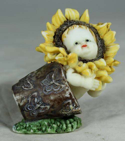 Ceramic baby in a flower pot