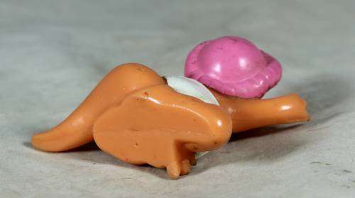 Nappy baby dinosaur wearing a pink bonnet