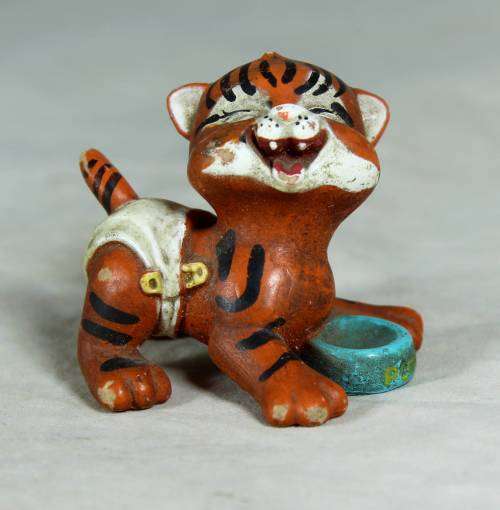 Nappy baby tiger with his bowl