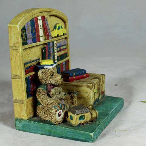 Ceramic papa bear with a baby bear in a bookstore