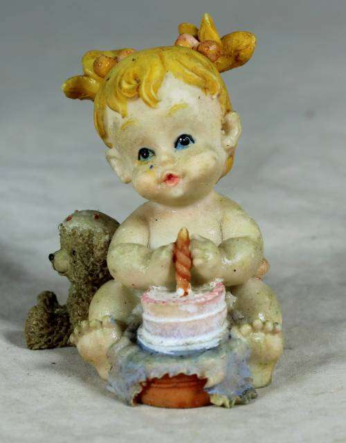 Ceramic little girl with her birthday cake