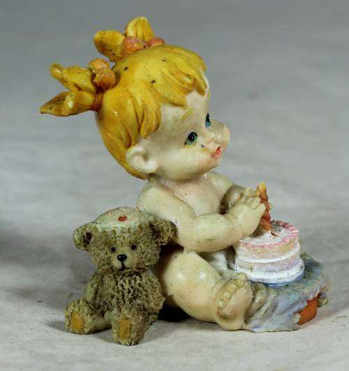 Ceramic little girl with her birthday cake