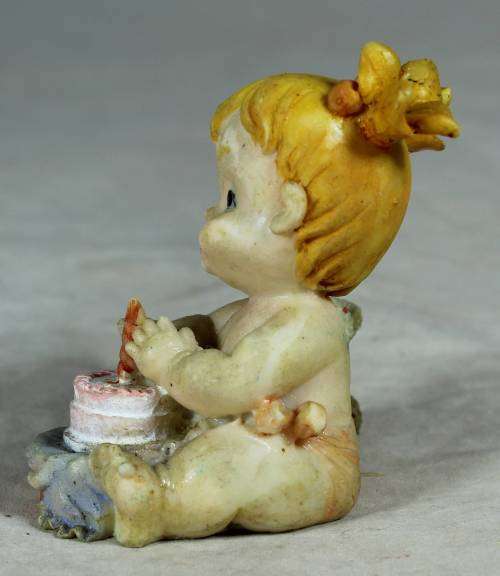 Ceramic little girl with her birthday cake