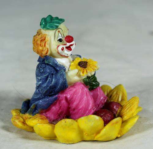 CERAMIC CLOWN SITTING IN A SUNFLOWER  (COOL) -BID NOW !!!