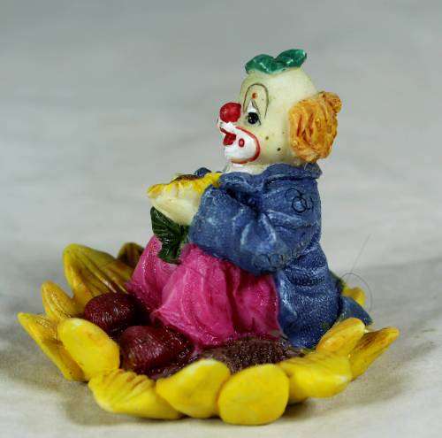CERAMIC CLOWN SITTING IN A SUNFLOWER  (COOL) -BID NOW !!!
