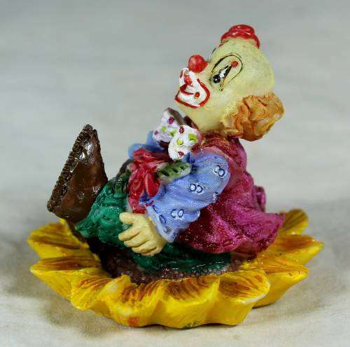 CERAMIC CLOWN SITTING IN A SUNFLOWER  (SMILING) -BID NOW !!!