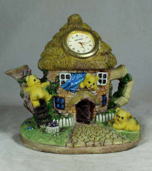 Ceramic house with a clock and bear