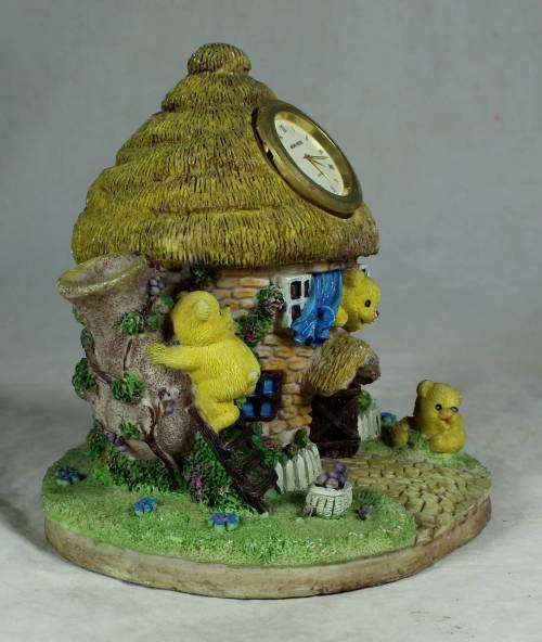 Ceramic house with a clock and bear