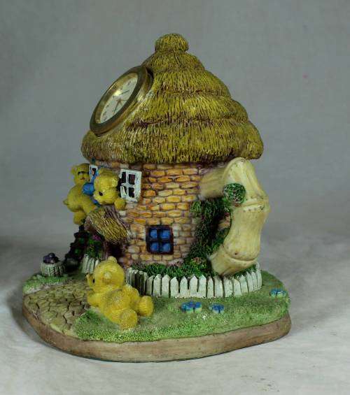 Ceramic house with a clock and bear