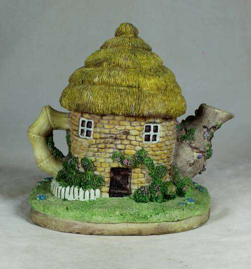 Ceramic house with a clock and bear