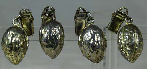 Four metal table cloth holders