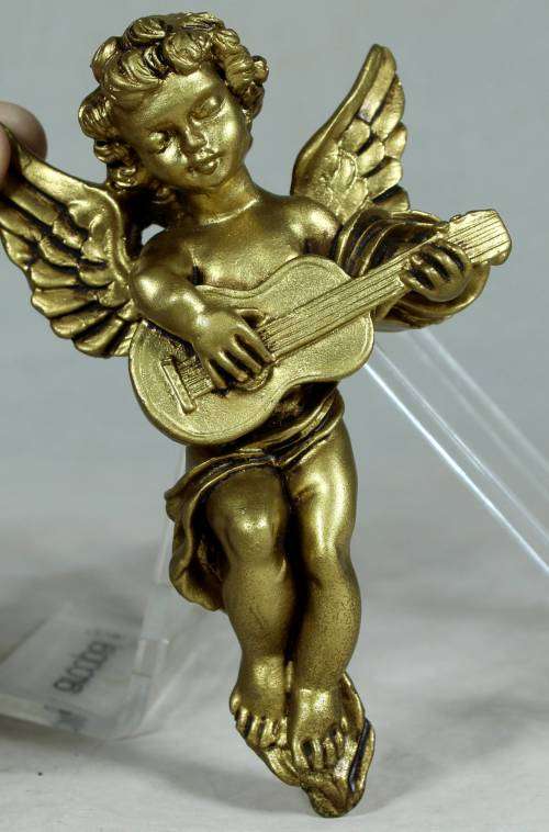 Molded cherub playing guitar