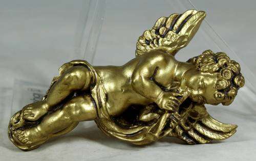 Molded cherub playing the flute