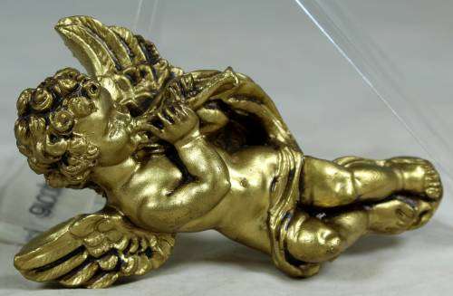 Molded cherub playing the flute