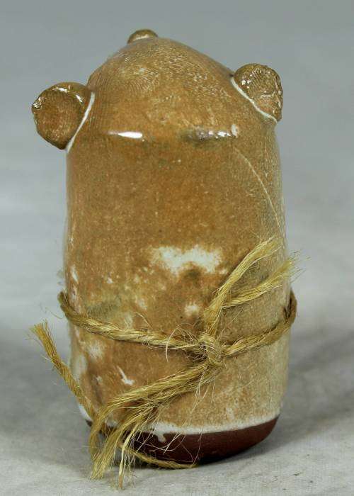 Carved stone mouse holding flowers