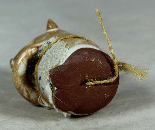 Carved stone mouse holding flowers