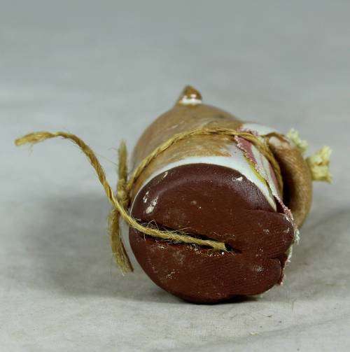 Carved stone mouse holding flowers