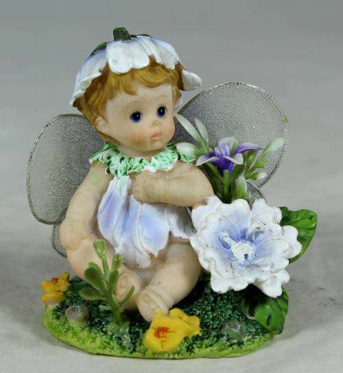 Baby fairy sitting among the flowers