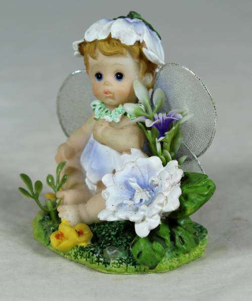Baby fairy sitting among the flowers