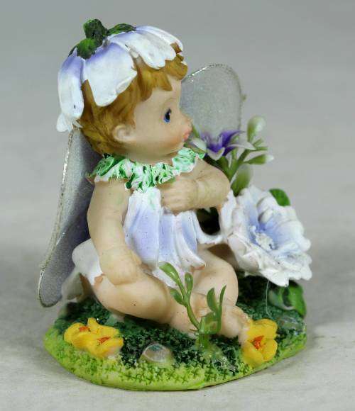 Baby fairy sitting among the flowers