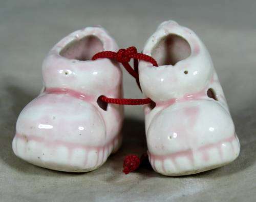 miniature pair of porcelain baby shoes