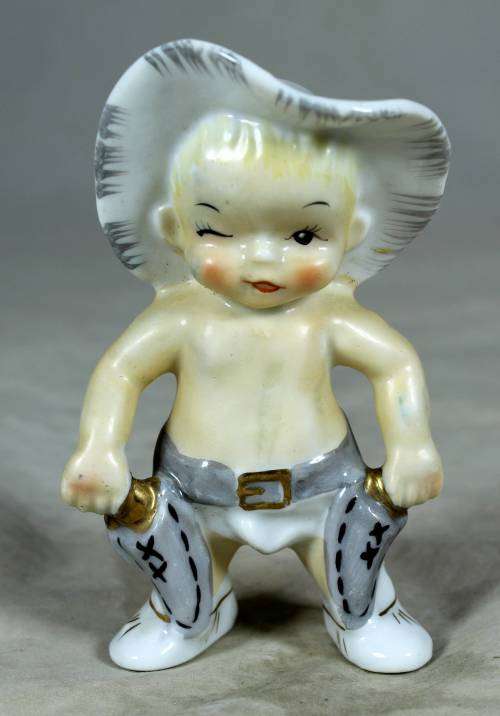 Porcelain standing cowboy baby, ready for action