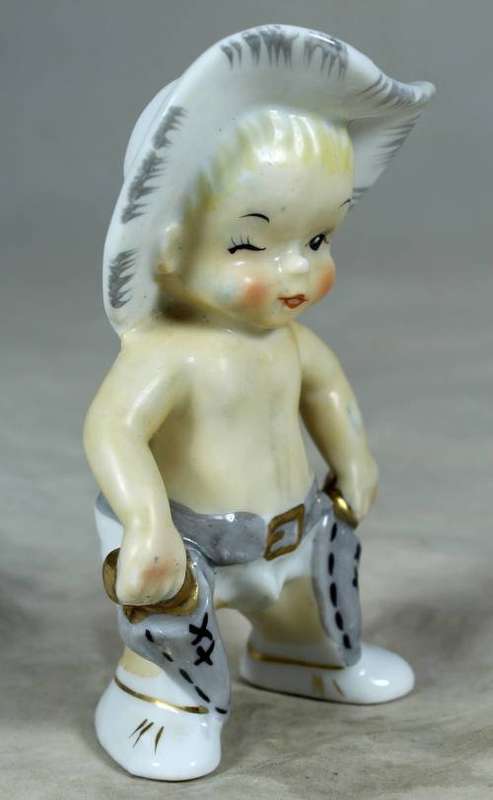 Porcelain standing cowboy baby, ready for action