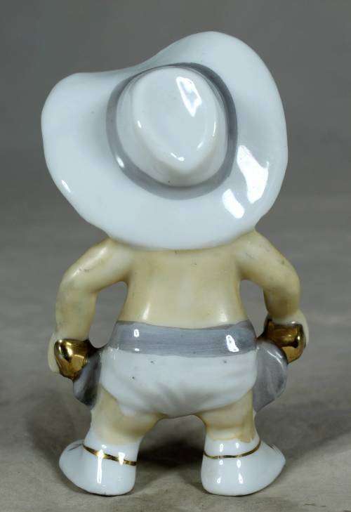 Porcelain standing cowboy baby, ready for action