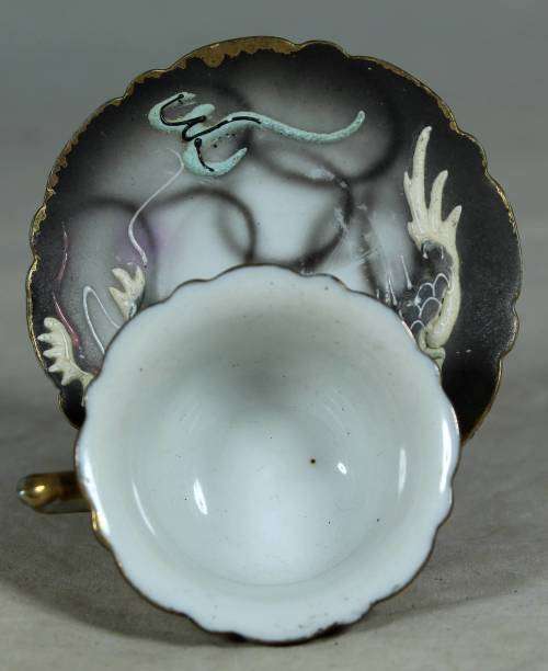 Miniature porcelain cup and saucer with a dragon