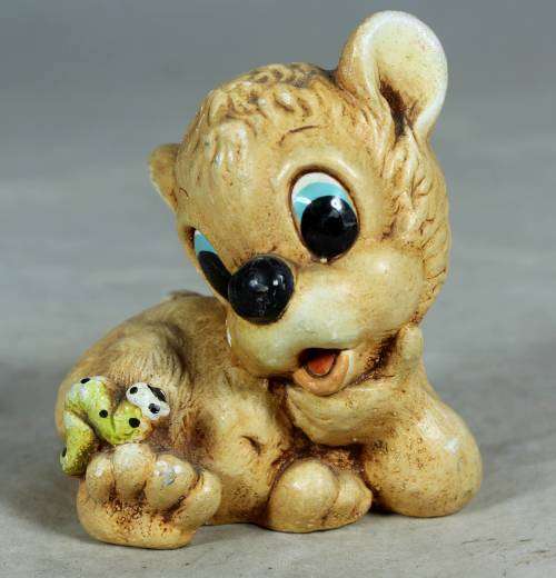 Little ceramic puppy with a worm on his paw