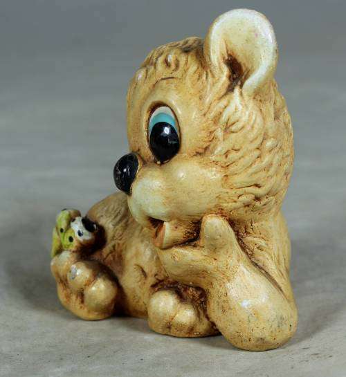 Little ceramic puppy with a worm on his paw