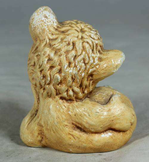 Little ceramic puppy with a worm on his paw