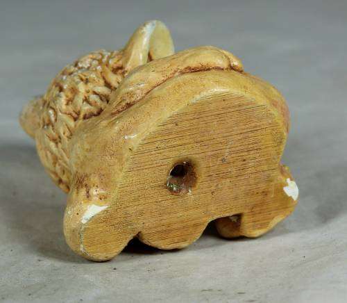 Little ceramic puppy with a worm on his paw