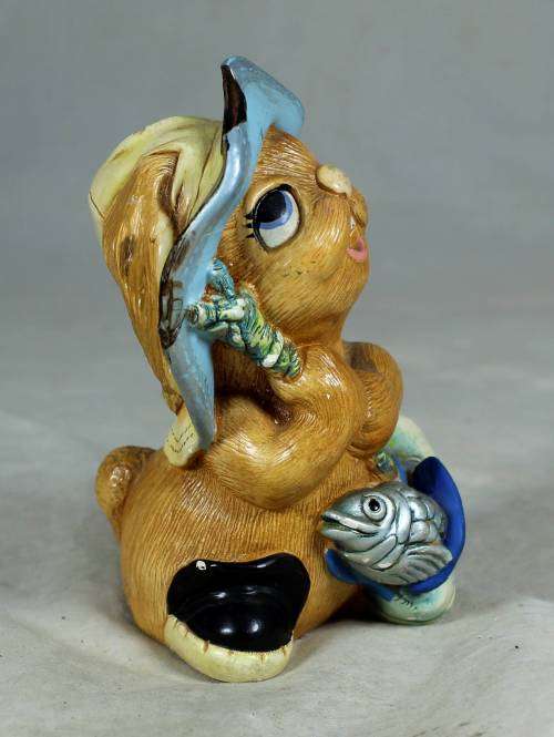 Hand painted stone craft rabbit with a fish and a shoe