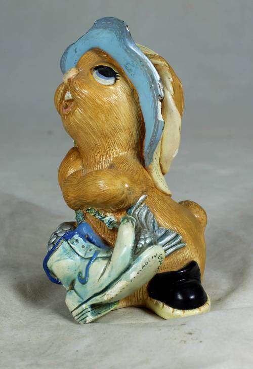 Hand painted stone craft rabbit with a fish and a shoe