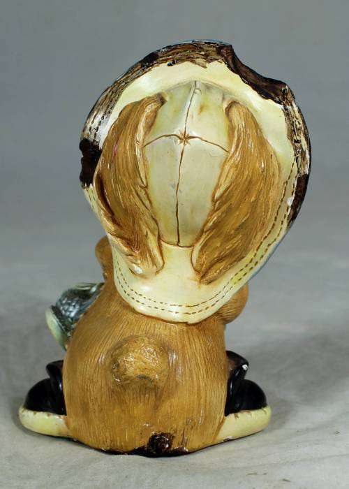 Hand painted stone craft rabbit with a fish and a shoe