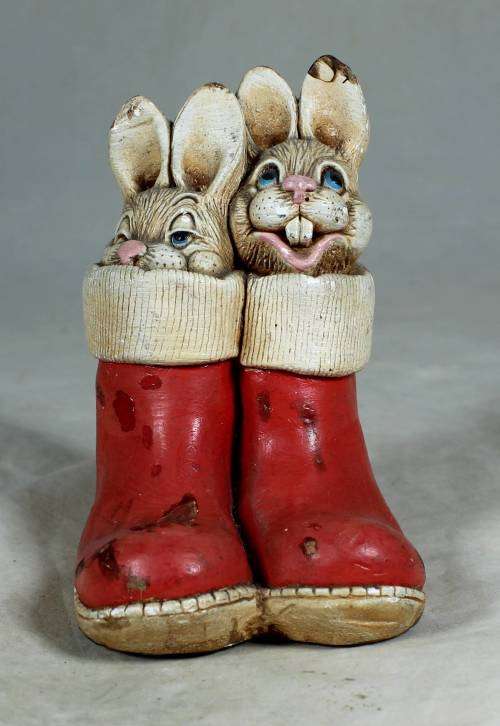 hand painted stone craft rabbits in a red pair of shoes