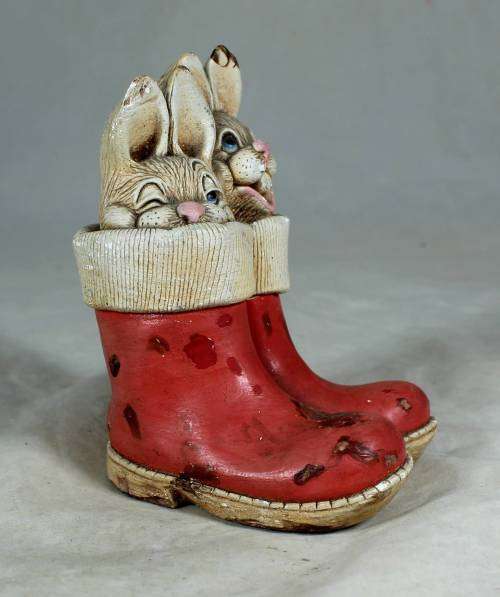 hand painted stone craft rabbits in a red pair of shoes