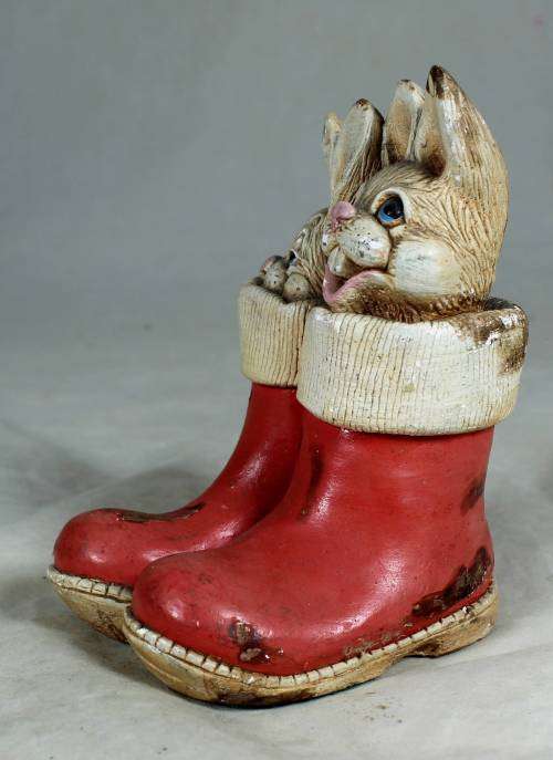 hand painted stone craft rabbits in a red pair of shoes