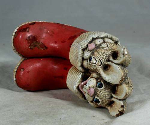 hand painted stone craft rabbits in a red pair of shoes