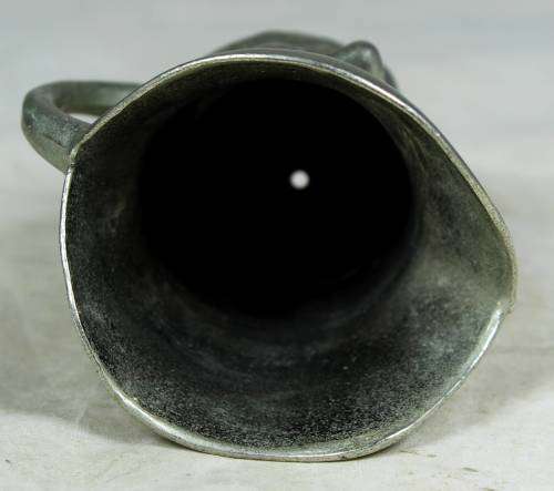 Small metal jug with a face