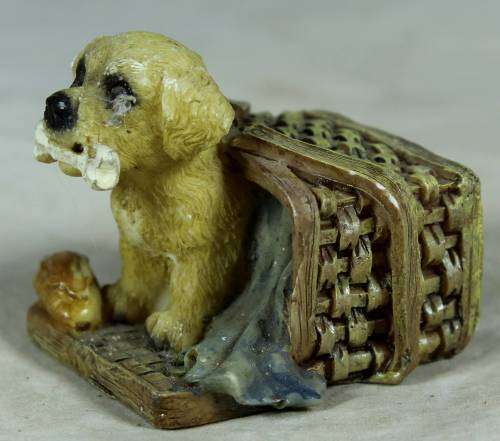 Miniature little puppy in a basket