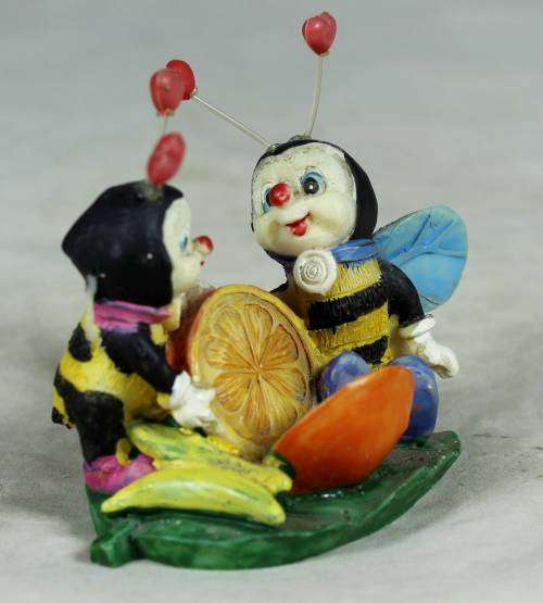Miniature little bees having fun with a lemon
